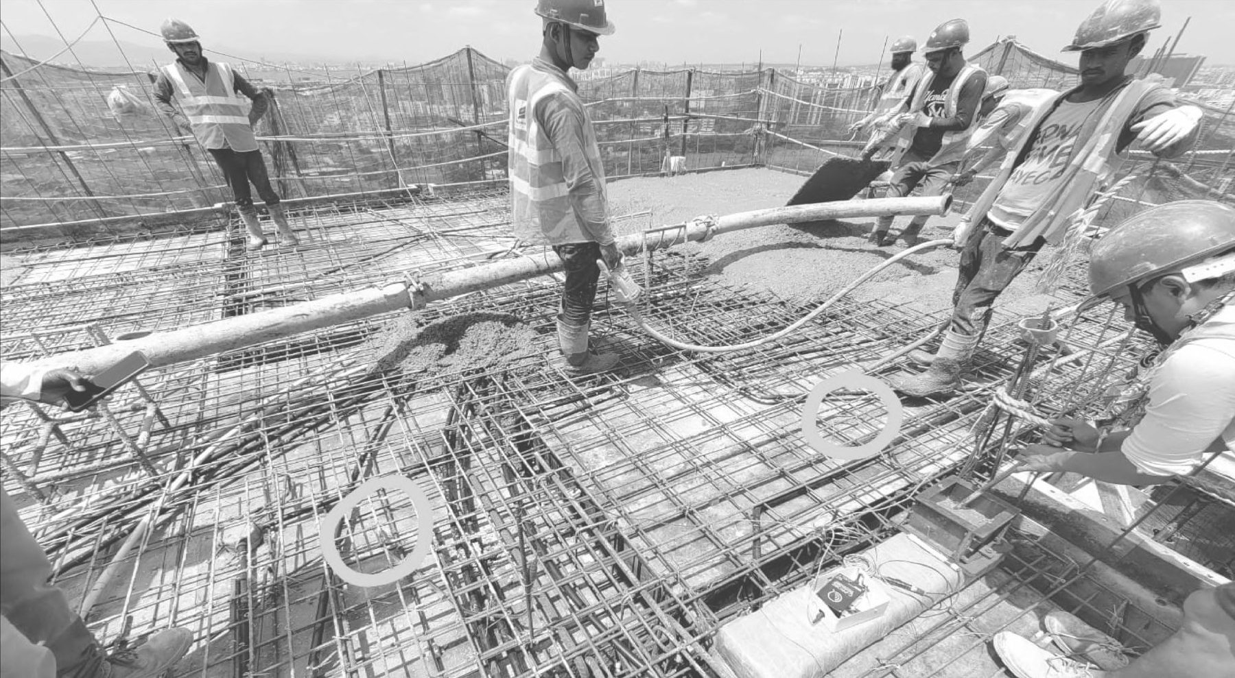 Site crew placing concrete on a reinforced slab with CP-CMMS monitoring